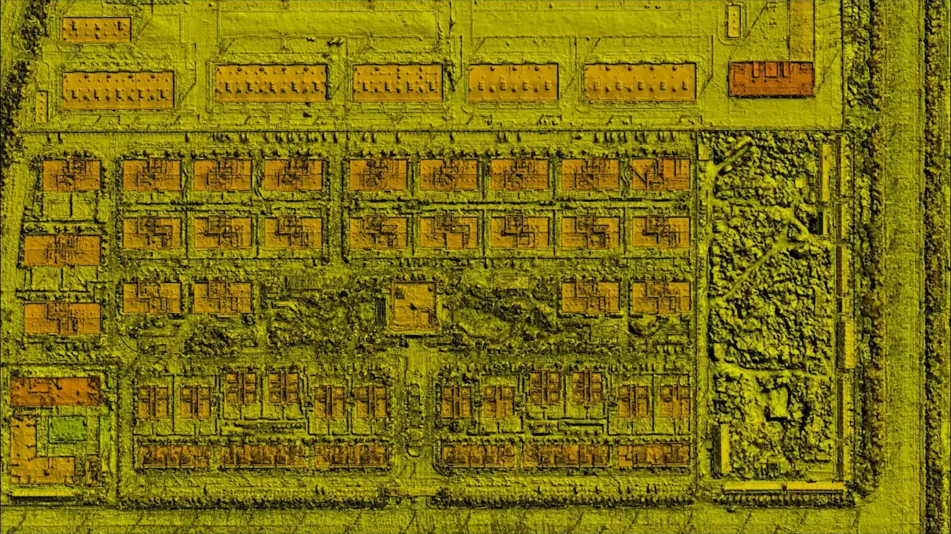 The identical frame from the same aircraft in thermal: the same roofs, streets and plot rendered by heat instead of light